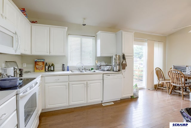 17103 Taylor St, Omaha, NE 68116 - kitchen with white appliances, a sink, light wood-style floors, light countertops, and white cabinets