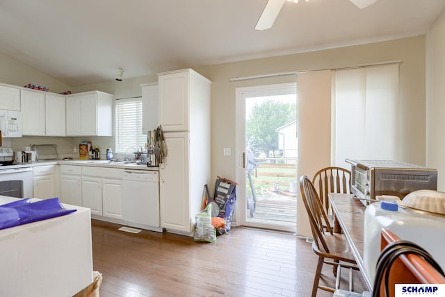 17103 Taylor St, Omaha, NE 68116 - kitchen featuring white appliances, healthy amount of natural light, light wood-type flooring, white cabinetry, and lofted ceiling