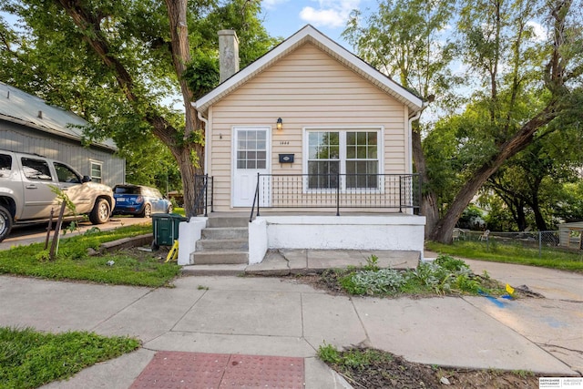 1444 S 16th St, Omaha, NE 68108 - view of front of house with covered porch and a chimney