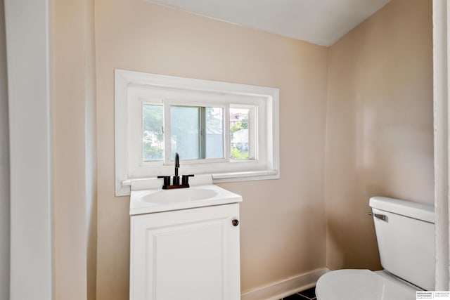 1444 S 16th St, Omaha, NE 68108 - bathroom with toilet, vanity, and baseboards
