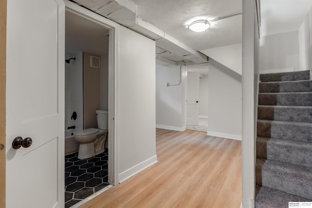 1444 S 16th St, Omaha, NE 68108 - interior space with wood finished floors, stairway, baseboards, and a textured ceiling