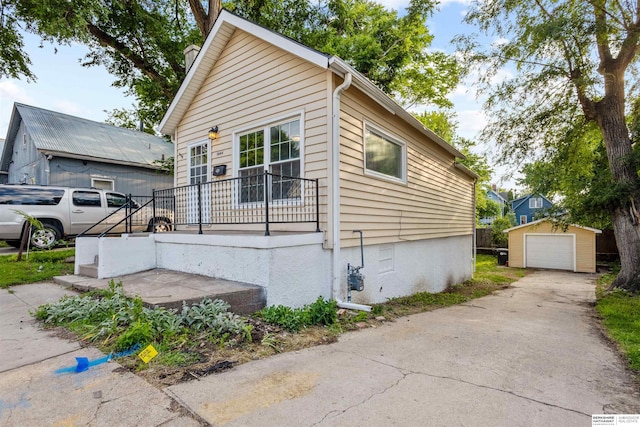1444 S 16th St, Omaha, NE 68108 - view of front of home with an outbuilding, asphalt driveway, and a detached garage