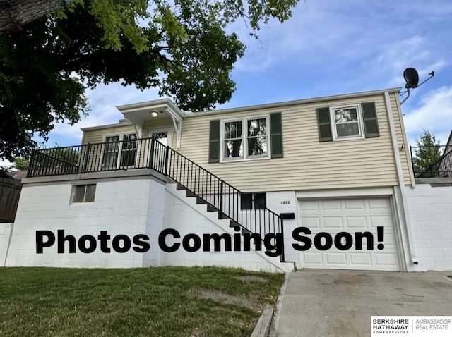 1511 S 60th St, Omaha, NE 68106 - view of front of house with an attached garage, stairway, and concrete driveway