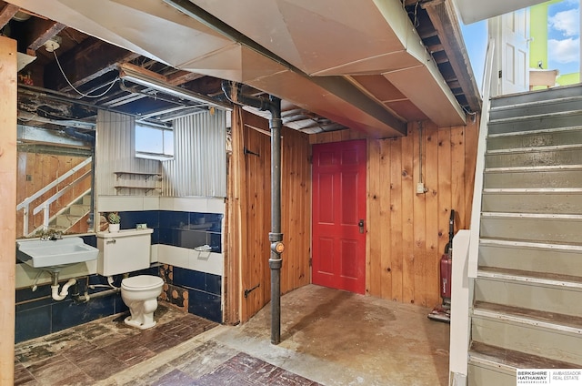 1511 S 60th St, Omaha, NE 68106 - below grade area with stairs, a sink, and wooden walls