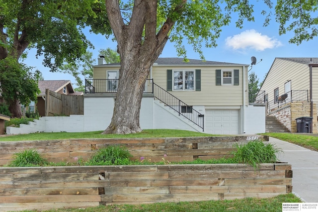 1511 S 60th St, Omaha, NE 68106 - view of front of house with stairway, an attached garage, and driveway
