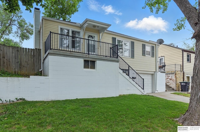 1511 S 60th St, Omaha, NE 68106 - back of property featuring stairs, a chimney, an attached garage, and a balcony