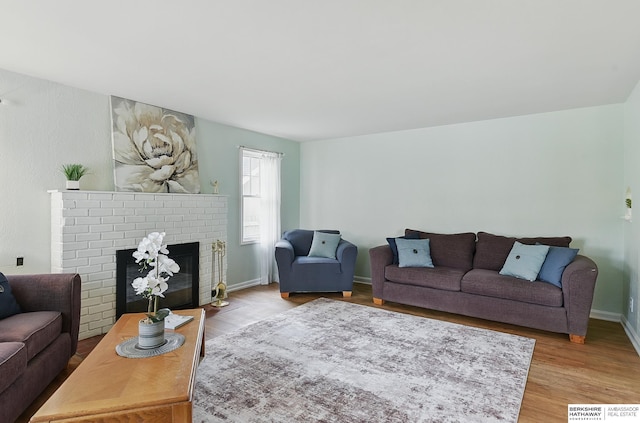 1511 S 60th St, Omaha, NE 68106 - living room with wood finished floors, a brick fireplace, and baseboards