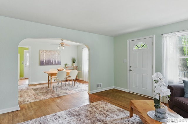 1511 S 60th St, Omaha, NE 68106 - entrance foyer featuring arched walkways, a ceiling fan, and wood finished floors