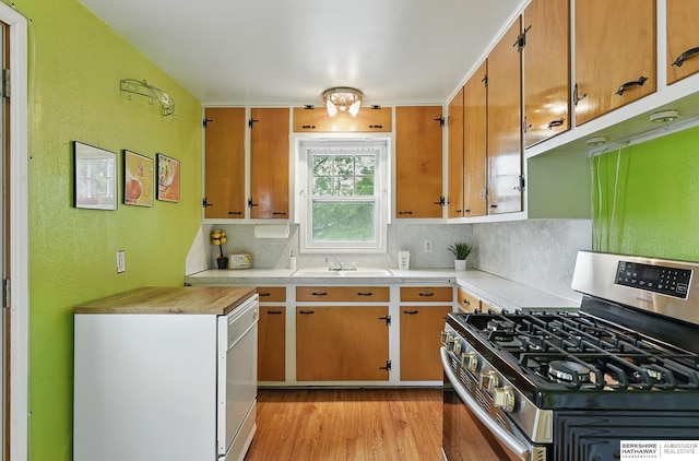1511 S 60th St, Omaha, NE 68106 - kitchen with stainless steel gas range, dishwasher, light countertops, and backsplash