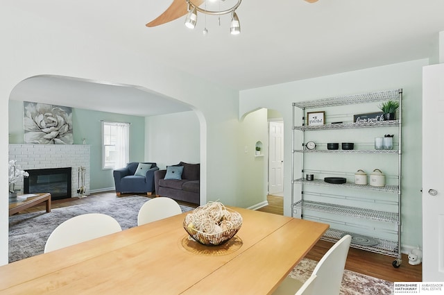 1511 S 60th St, Omaha, NE 68106 - dining space with arched walkways, wood finished floors, a ceiling fan, and baseboards