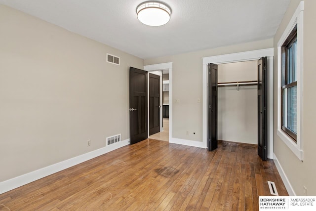 17409 Webster Blvd, Plattsmouth, NE 68048 - unfurnished bedroom featuring light wood-type flooring, a closet, and baseboards