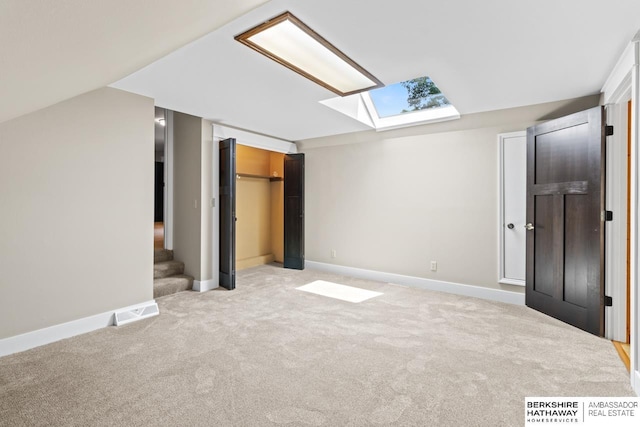 17409 Webster Blvd, Plattsmouth, NE 68048 - unfurnished bedroom featuring a skylight, carpet flooring, baseboards, and a closet