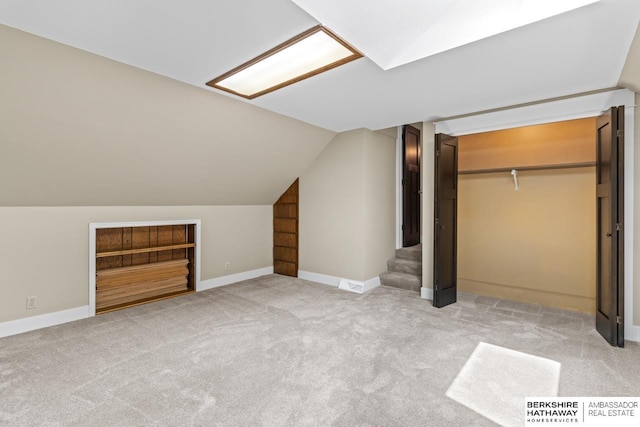 17409 Webster Blvd, Plattsmouth, NE 68048 - bonus room with light colored carpet, vaulted ceiling, stairway, and baseboards