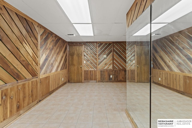 17409 Webster Blvd, Plattsmouth, NE 68048 - spare room with wooden walls and light tile patterned flooring