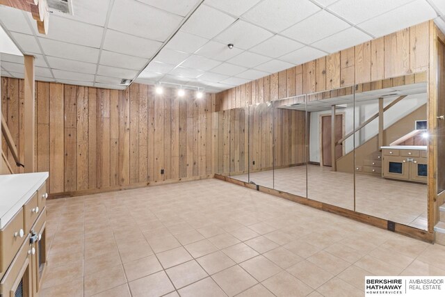 17409 Webster Blvd, Plattsmouth, NE 68048 - finished basement featuring a paneled ceiling, wood walls, and stairway
