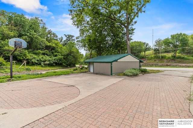 17409 Webster Blvd, Plattsmouth, NE 68048 - view of patio with an outbuilding, view of wooded area, and a detached garage