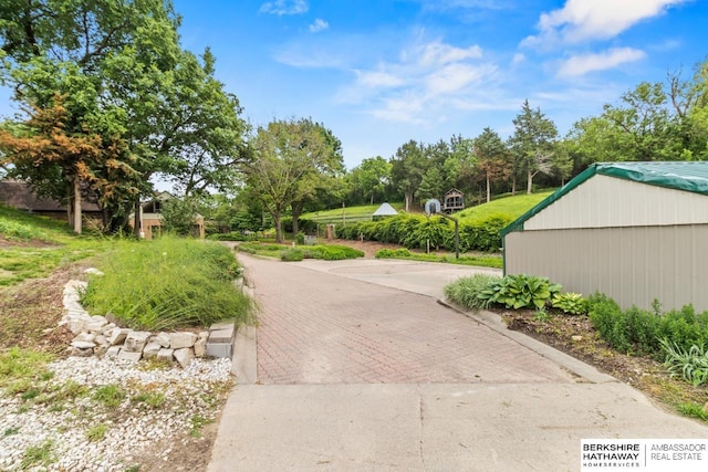 17409 Webster Blvd, Plattsmouth, NE 68048 - view of concrete driveway featuring view of wooded area