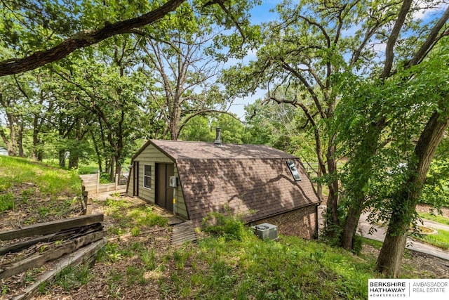 17409 Webster Blvd, Plattsmouth, NE 68048 - view of home's exterior featuring a gambrel roof, roof with shingles, cooling unit, and an outbuilding