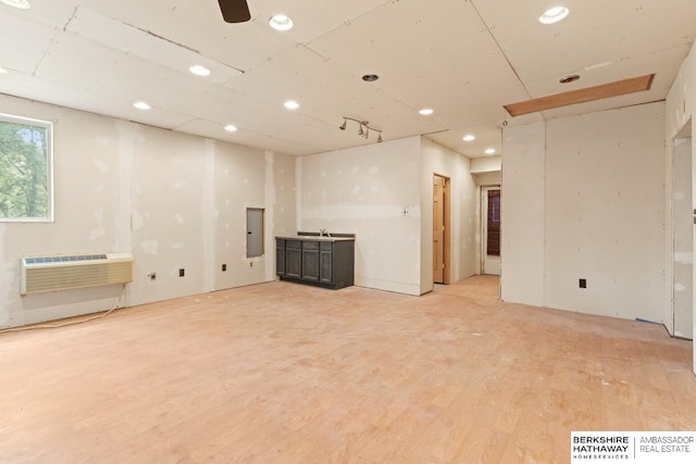 17409 Webster Blvd, Plattsmouth, NE 68048 - below grade area featuring recessed lighting, light wood-type flooring, an AC wall unit, and electric panel