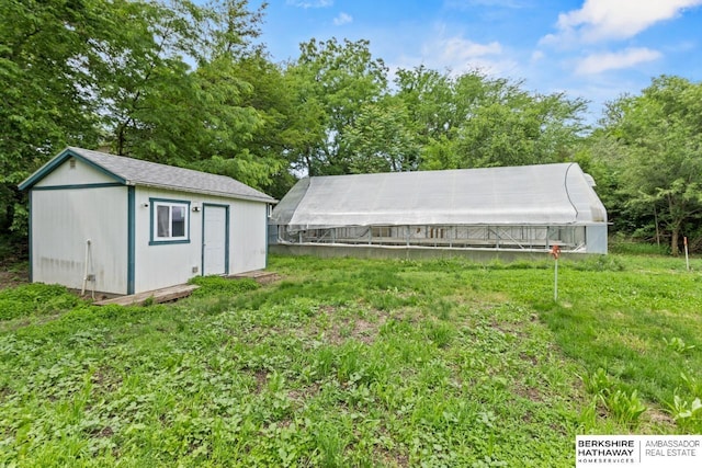 17409 Webster Blvd, Plattsmouth, NE 68048 - view of yard featuring an outdoor structure and view of wooded area