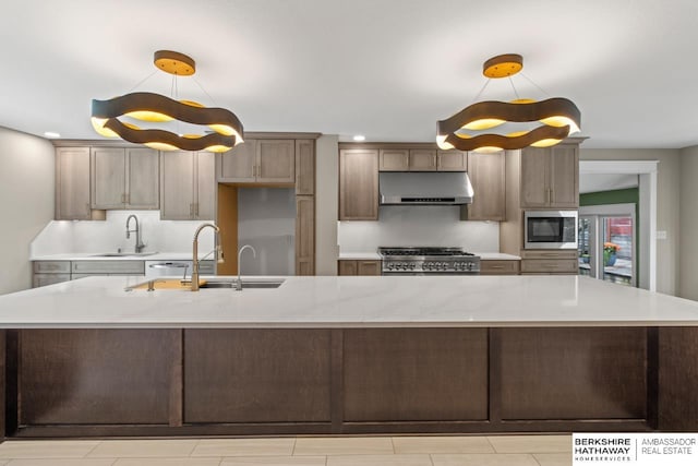 17409 Webster Blvd, Plattsmouth, NE 68048 - kitchen featuring under cabinet range hood, stainless steel microwave, a sink, stove, and recessed lighting