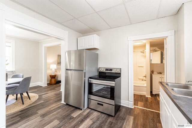 4328 Burdette St, Omaha, NE 68111 - kitchen with appliances with stainless steel finishes, dark wood-type flooring, a sink, white cabinetry, and a drop ceiling