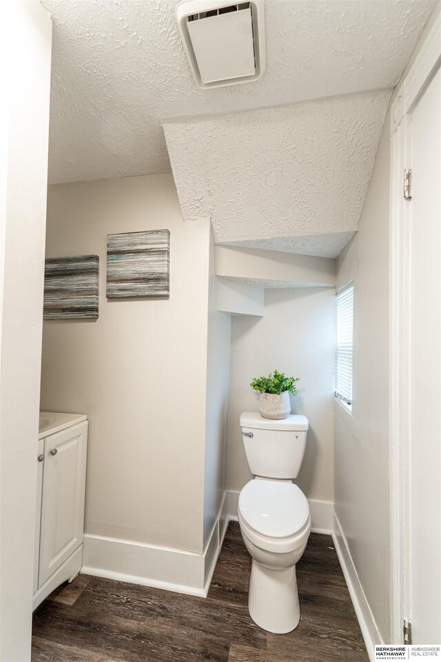 4328 Burdette St, Omaha, NE 68111 - bathroom with a textured ceiling, toilet, wood finished floors, and baseboards