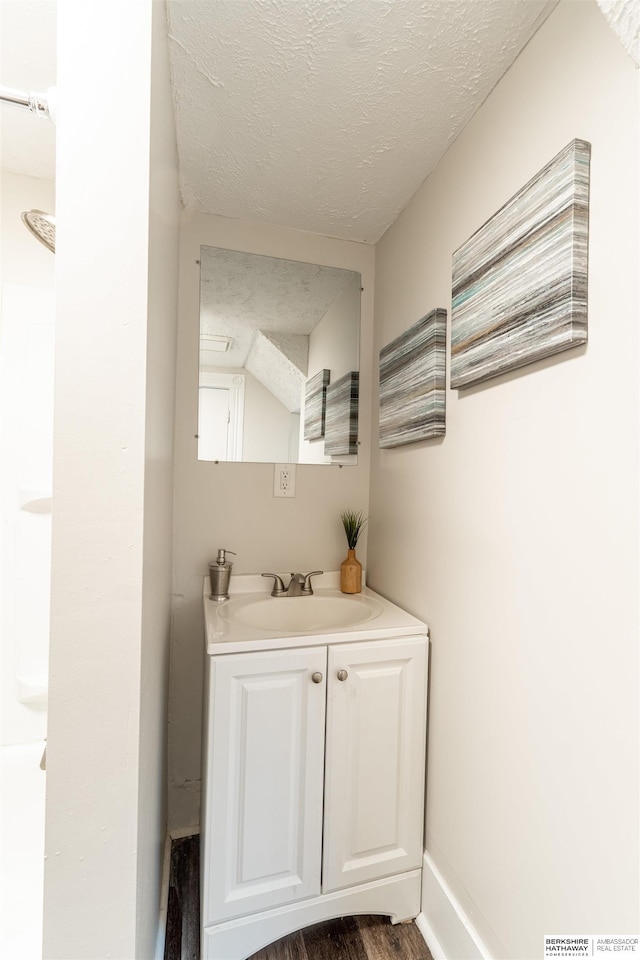 4328 Burdette St, Omaha, NE 68111 - bathroom with a textured ceiling, vanity, wood finished floors, and baseboards