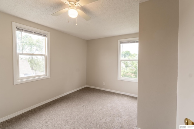 4328 Burdette St, Omaha, NE 68111 - carpeted empty room featuring a textured ceiling, plenty of natural light, baseboards, and a ceiling fan