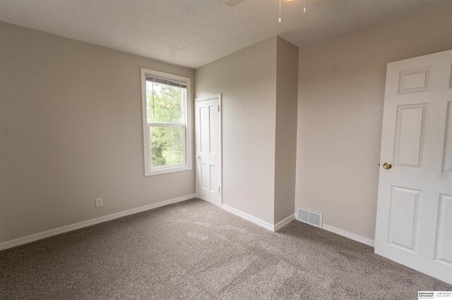4328 Burdette St, Omaha, NE 68111 - carpeted empty room with baseboards, a textured ceiling, and a ceiling fan