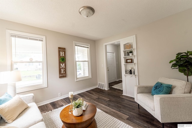4328 Burdette St, Omaha, NE 68111 - living area featuring dark wood-style floors, baseboards, and a textured ceiling
