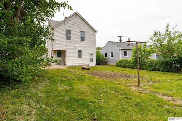 4328 Burdette St, Omaha, NE 68111 - rear view of property with cooling unit and a lawn