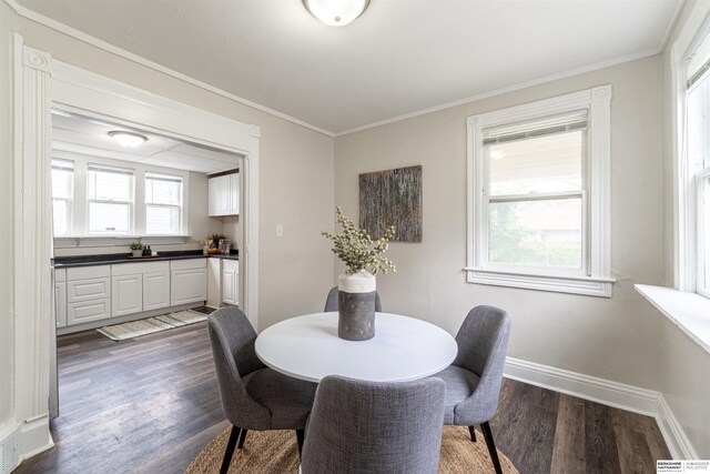 4328 Burdette St, Omaha, NE 68111 - dining area featuring dark wood finished floors, baseboards, and ornamental molding
