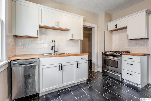 620 Dorcas St, Omaha, NE 68108 - kitchen with wood counters, stainless steel appliances, a sink, white cabinets, and tasteful backsplash