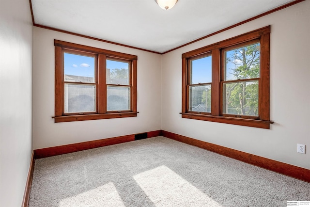 620 Dorcas St, Omaha, NE 68108 - spare room featuring carpet flooring, plenty of natural light, ornamental molding, and baseboards