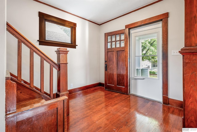 620 Dorcas St, Omaha, NE 68108 - entrance foyer with wood finished floors, ornamental molding, baseboards, and stairs