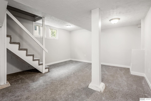 620 Dorcas St, Omaha, NE 68108 - below grade area featuring carpet, a textured ceiling, baseboards, and stairway