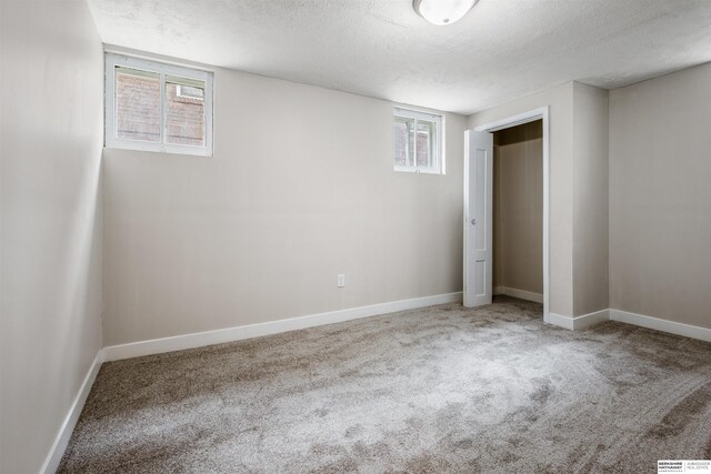 620 Dorcas St, Omaha, NE 68108 - unfurnished bedroom with a textured ceiling, carpet floors, baseboards, and a closet