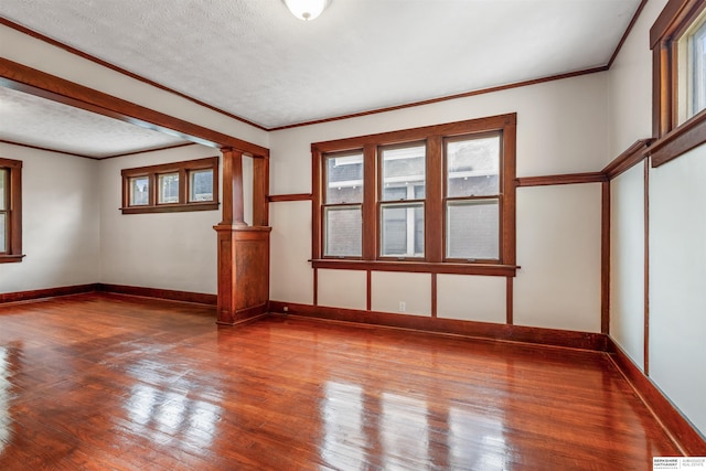 620 Dorcas St, Omaha, NE 68108 - spare room with wood finished floors, healthy amount of natural light, and crown molding
