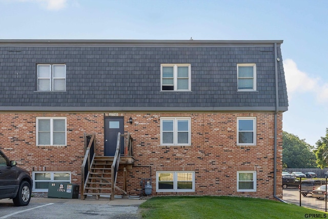 12749 Woodcrest Plz Unit 211B, Omaha, NE 68137 - view of front of home featuring mansard roof, brick siding, and uncovered parking