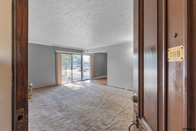 12749 Woodcrest Plz Unit 211B, Omaha, NE 68137 - carpeted spare room with crown molding, baseboards, and a textured ceiling