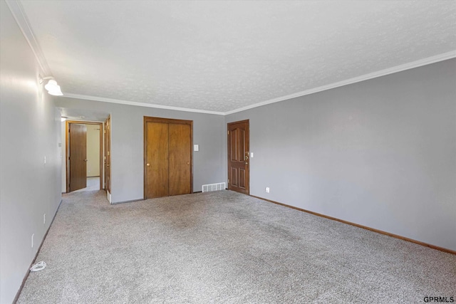 12749 Woodcrest Plz Unit 211B, Omaha, NE 68137 - unfurnished bedroom featuring light colored carpet, crown molding, a textured ceiling, baseboards, and a closet