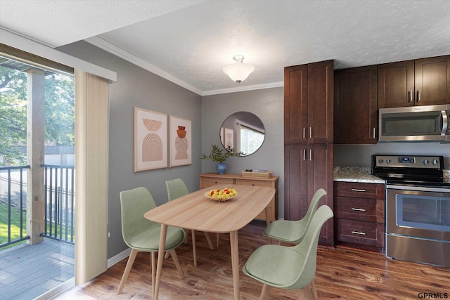 12749 Woodcrest Plz Unit 211B, Omaha, NE 68137 - dining area with dark wood-type flooring, plenty of natural light, crown molding, a textured ceiling, and baseboards