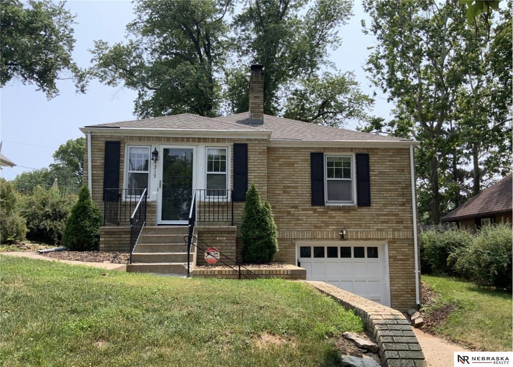 4315 Pierce St, Omaha, NE 68105 - view of front of property with an attached garage, a chimney, a front lawn, brick siding, and driveway