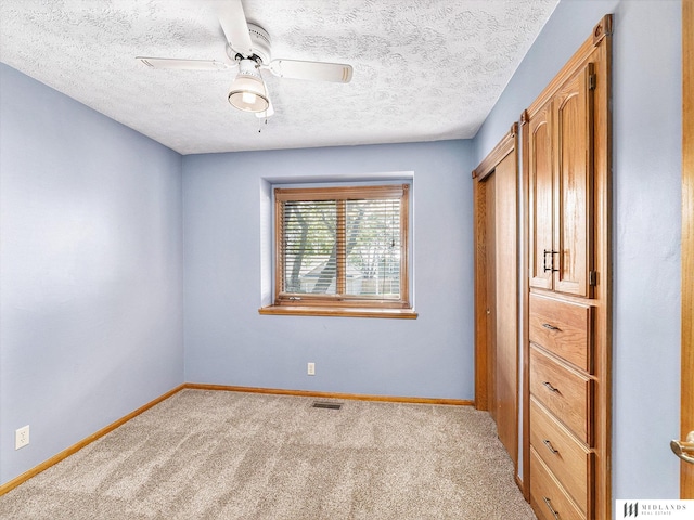 7824 La Vista Dr, La Vista, NE 68128 - unfurnished bedroom featuring carpet, a textured ceiling, and a ceiling fan
