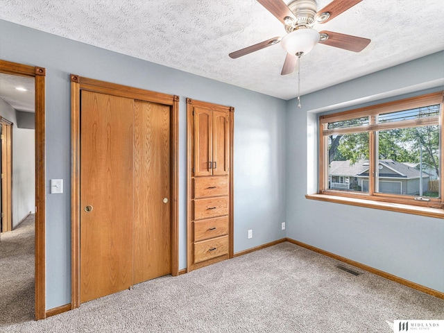 7824 La Vista Dr, La Vista, NE 68128 - unfurnished bedroom featuring light carpet, a textured ceiling, ceiling fan, and a closet