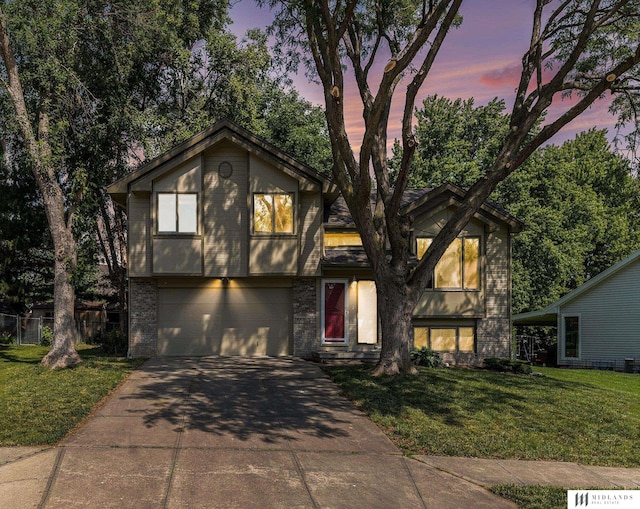 7824 La Vista Dr, La Vista, NE 68128 - tri-level home with concrete driveway, a garage, and brick siding
