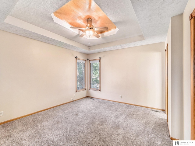 7824 La Vista Dr, La Vista, NE 68128 - carpeted spare room featuring a raised ceiling, ceiling fan, and a textured ceiling