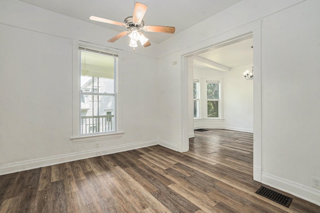 4701 Davenport St, Omaha, NE 68132 - unfurnished room with plenty of natural light, dark wood finished floors, a ceiling fan, and a chandelier