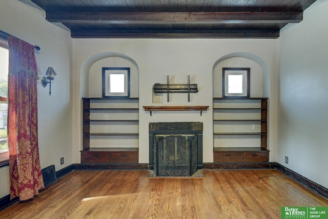 902 S 57th St, Omaha, NE 68106 - unfurnished living room with a wooden ceiling with exposed beams, wood finished floors, a fireplace, and built in features